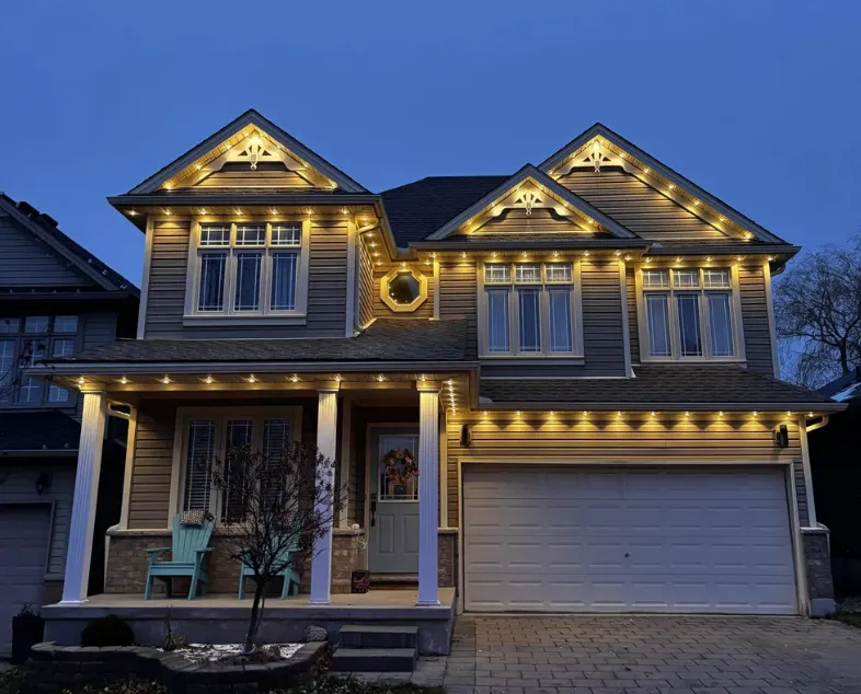 Permanent LED accent lighting installed along a home roofline at dusk